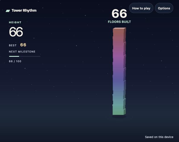 A tall rainbow tower of stacked blocks against a starry night sky, labelled 66 floors built